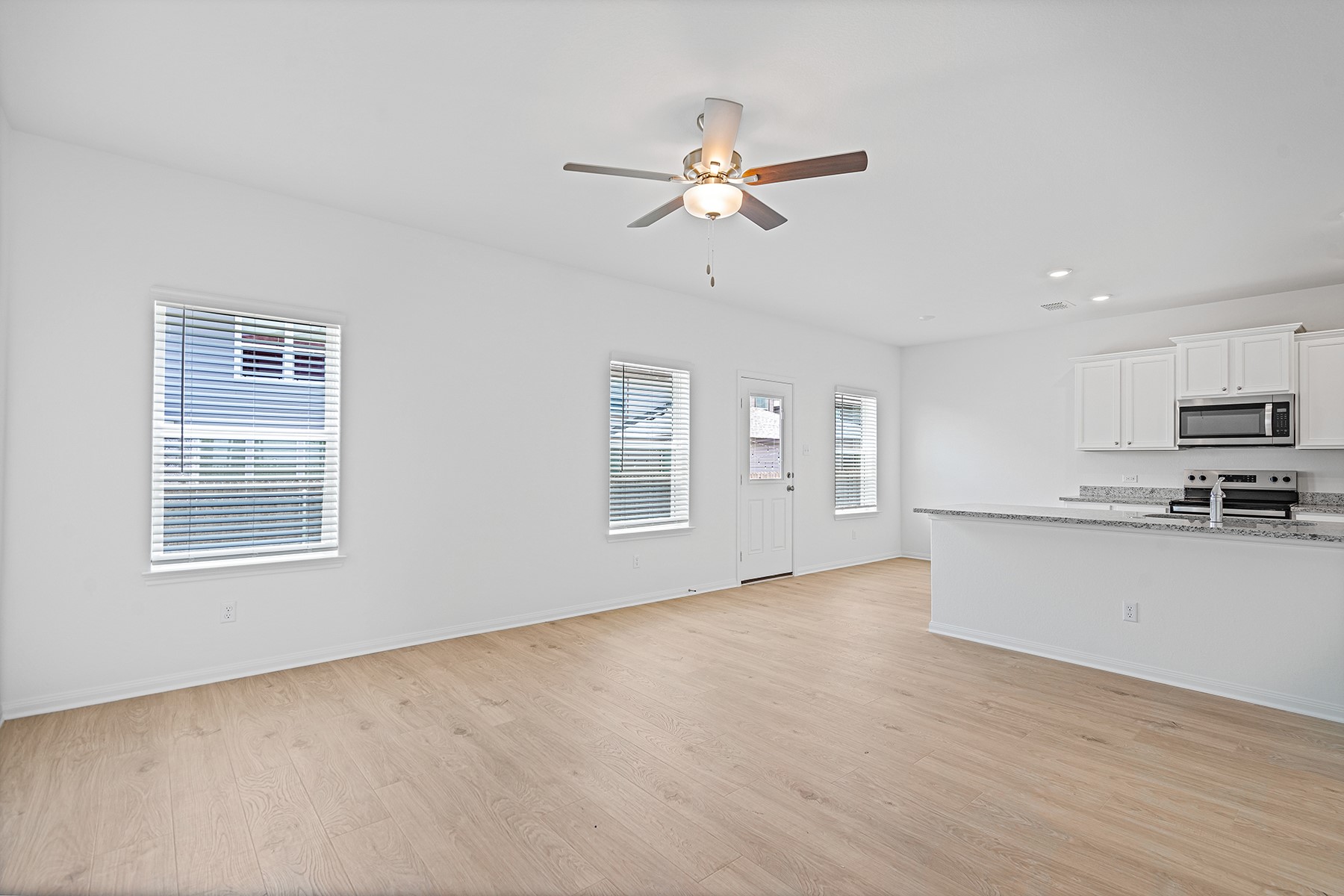 14524 Wahlbergs Way Elgin, TX 78621 - Photo 3 of 12 a view of empty room with wooden floor and window