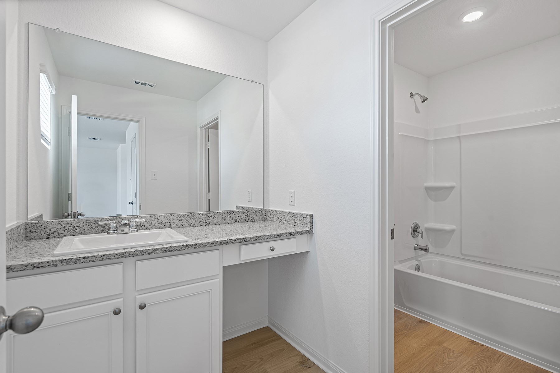 14524 Wahlbergs Way Elgin, TX 78621 - Photo 7 of 12 a bathroom with a granite countertop sink mirror and a bath tub