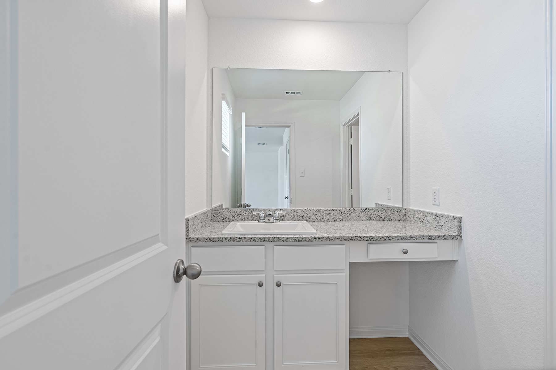 14524 Wahlbergs Way Elgin, TX 78621 - Photo 8 of 12 a bathroom with a granite countertop sink and a mirror