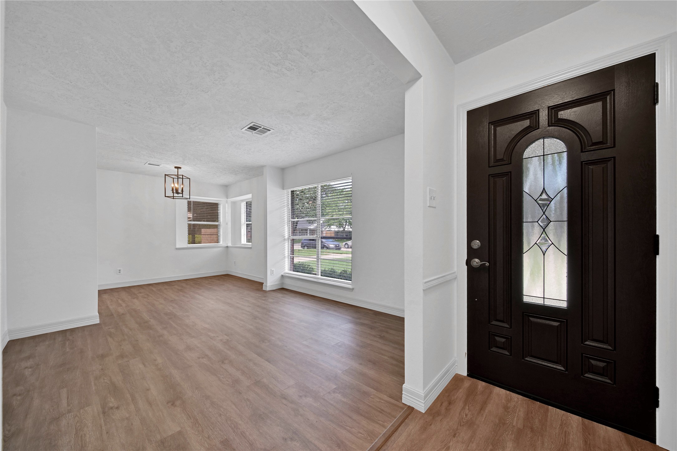 9411 Roos Road Houston, TX 77036 - Photo 7 of 41 an empty room with wooden floor windows and closet
