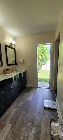 a spacious bathroom with a granite countertop sink and a mirror