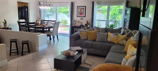 a living room with furniture and large windows