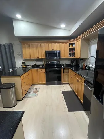 a kitchen with granite countertop a stove sink and cabinets