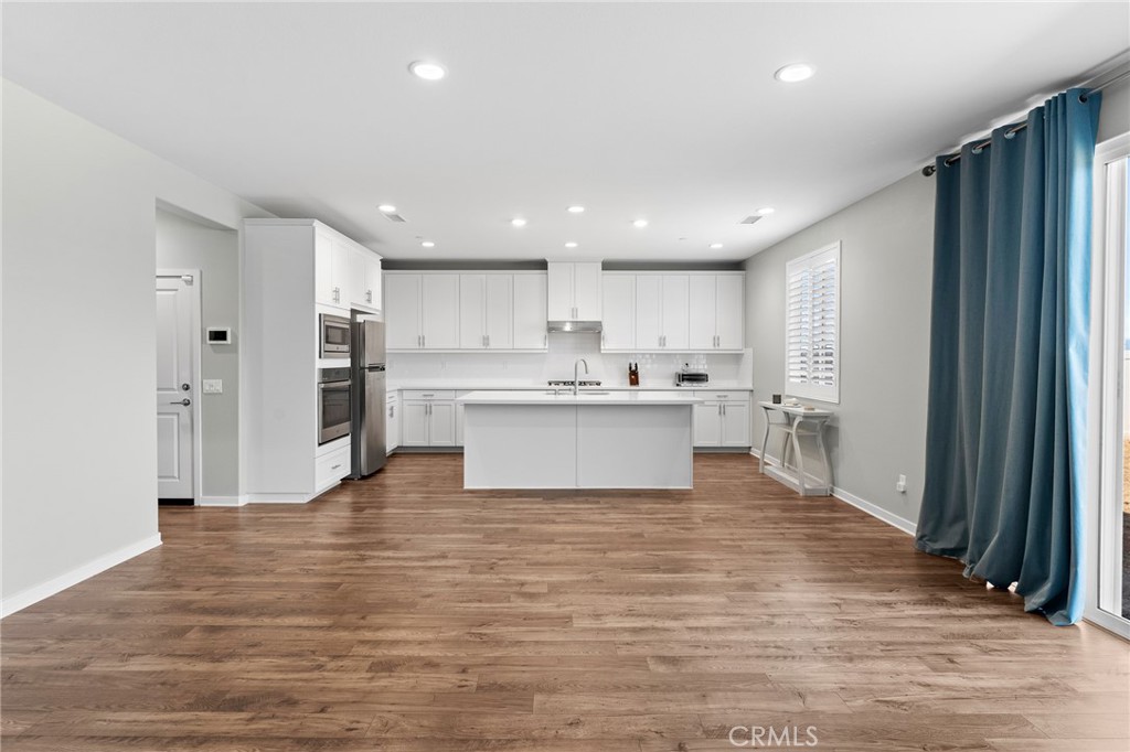 36772 Arietta Way Beaumont, CA 92223 - Photo 12 of 45 a view of kitchen with wooden floor