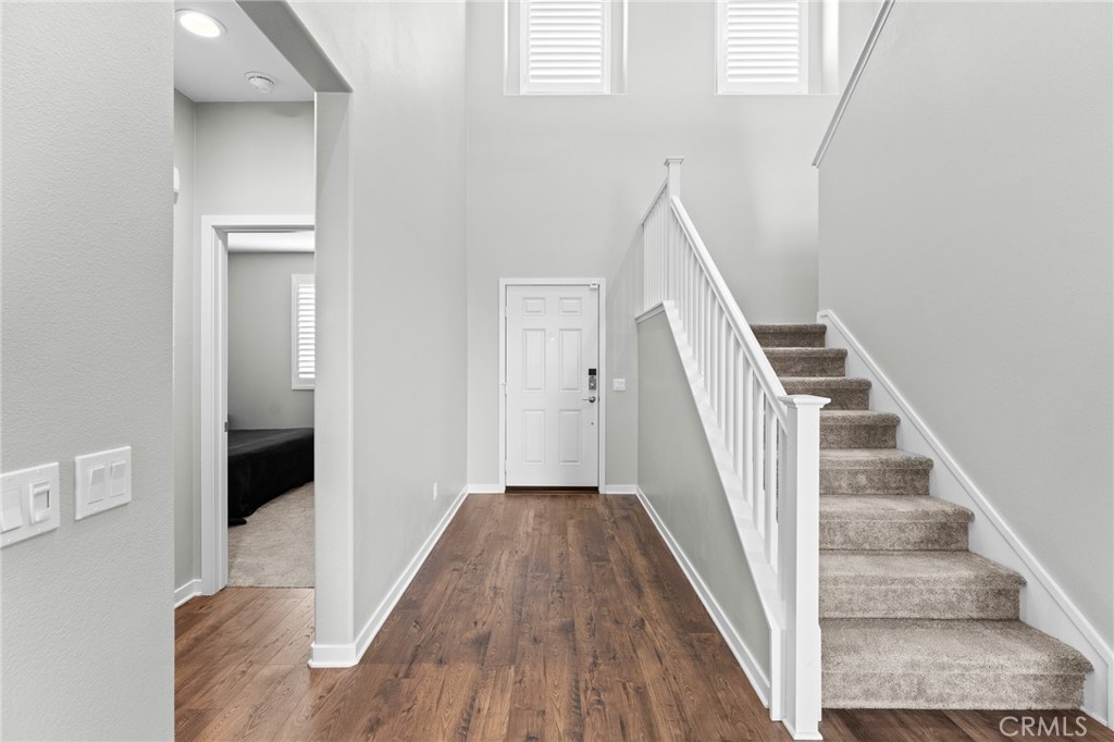 36772 Arietta Way Beaumont, CA 92223 - Photo 20 of 45 a view of a hallway with wooden floor and entryway