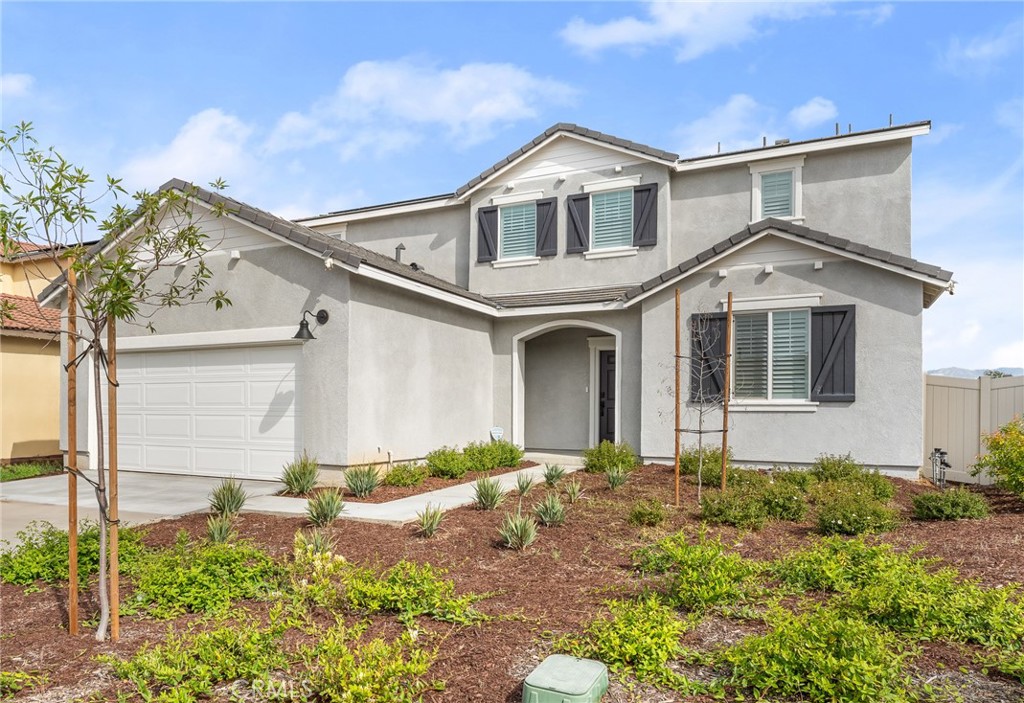 36772 Arietta Way Beaumont, CA 92223 - Photo 2 of 45 a front view of a house with a yard