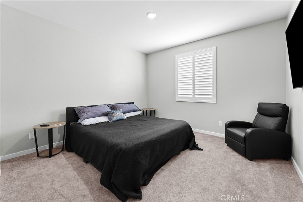 36772 Arietta Way Beaumont, CA 92223 - Photo 22 of 45 a bedroom with a bed and a couch