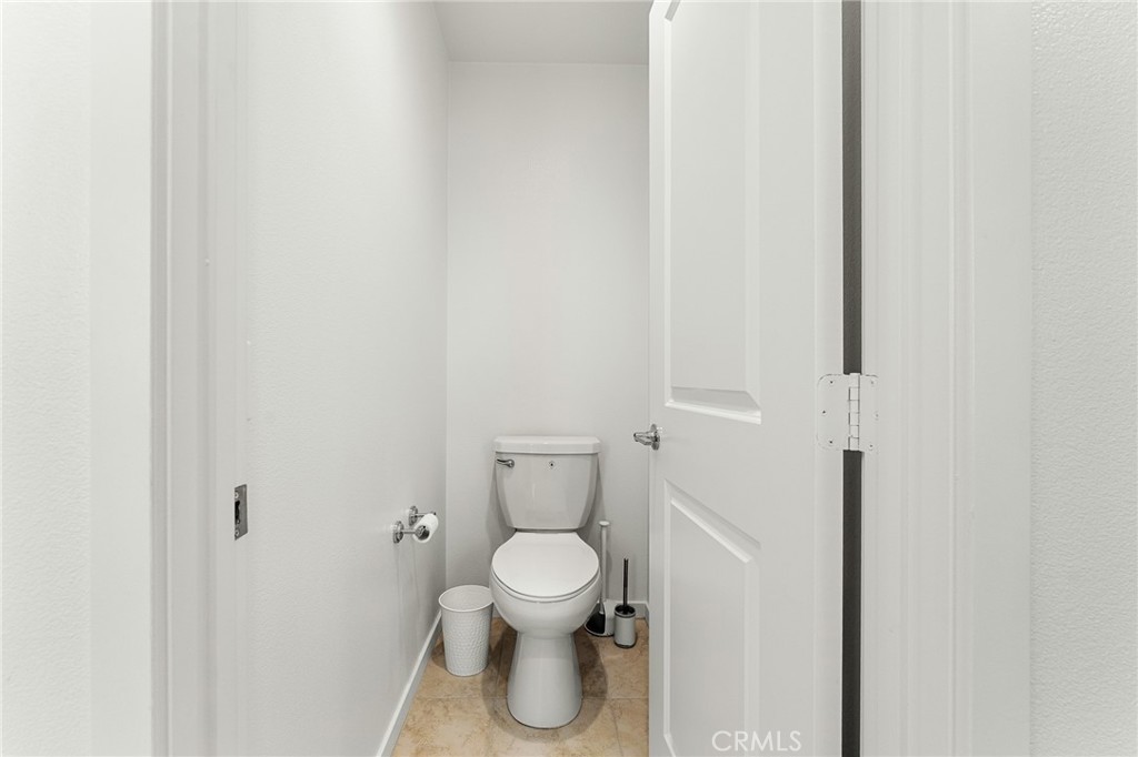 36772 Arietta Way Beaumont, CA 92223 - Photo 23 of 45 a white toilet sitting next to a white walls