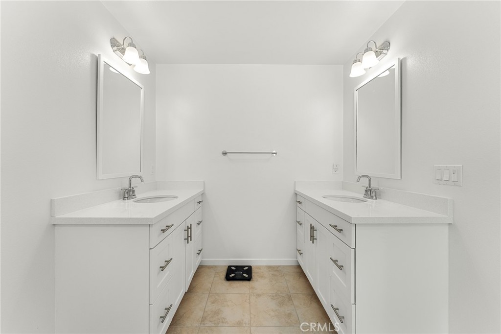 36772 Arietta Way Beaumont, CA 92223 - Photo 27 of 45 a bathroom with a double vanity sink and a mirror