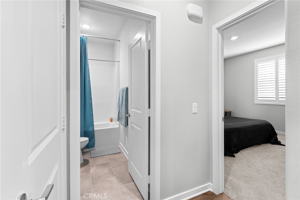 36772 Arietta Way Beaumont, CA 92223 - Photo 31 of 45 a view of a bedroom with a bed and hallway
