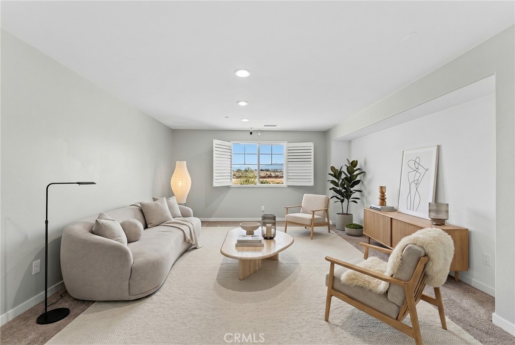 36772 Arietta Way Beaumont, CA 92223 - Photo 35 of 45 a living room with furniture and a potted plant