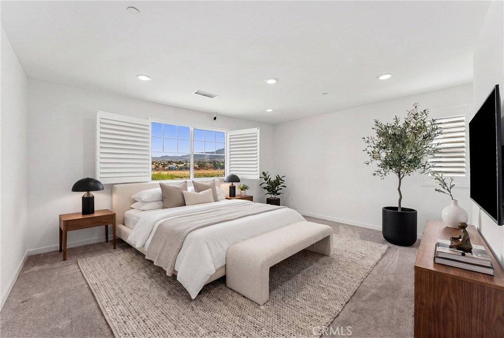 36772 Arietta Way Beaumont, CA 92223 - Photo 40 of 45 a bedroom with a bed and a flat screen tv