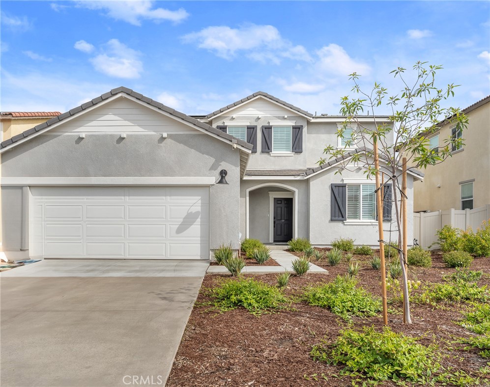 36772 Arietta Way Beaumont, CA 92223 - Photo 4 of 45 a view of a white house next to a yard