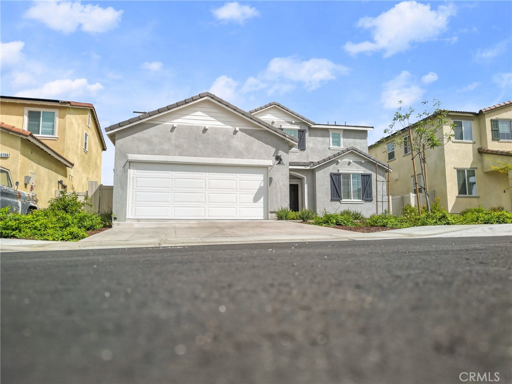 36772 Arietta Way Beaumont, CA 92223 - Photo 5 of 45 a view of a white house with a street