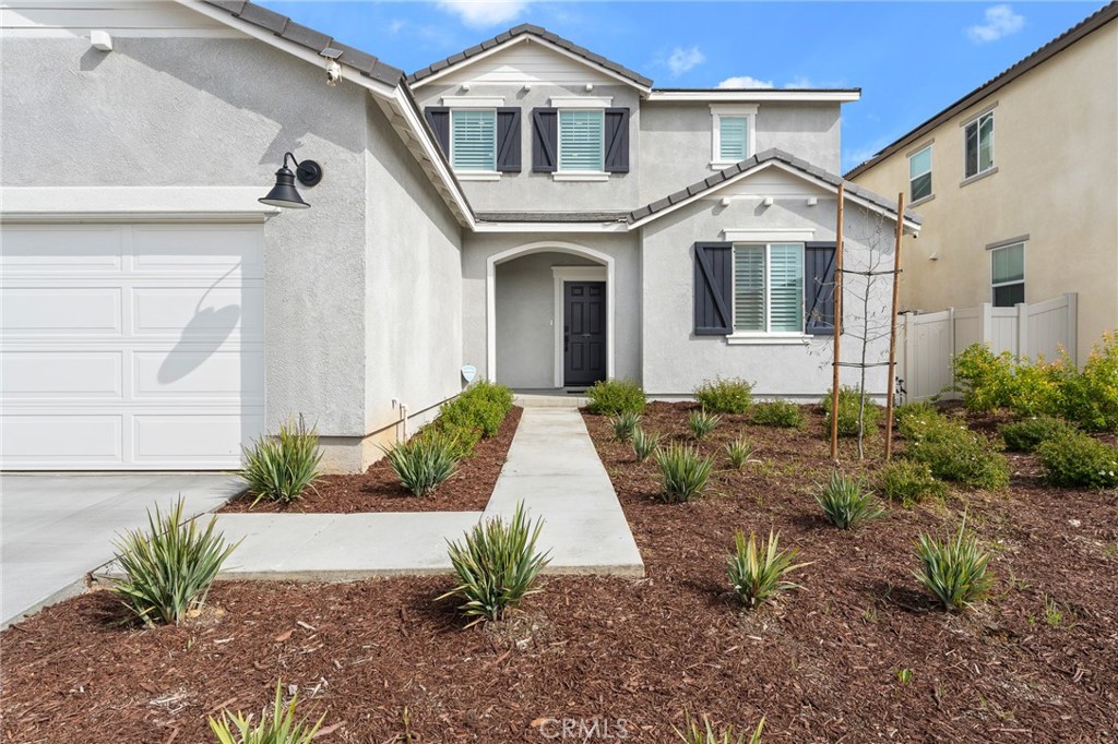 36772 Arietta Way Beaumont, CA 92223 - Photo 6 of 45 a front view of a house with a yard