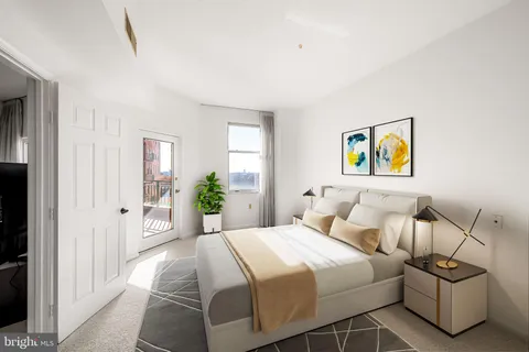 a bedroom with a large bed and a sink