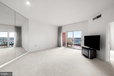 a view of a livingroom with furniture and flat screen tv