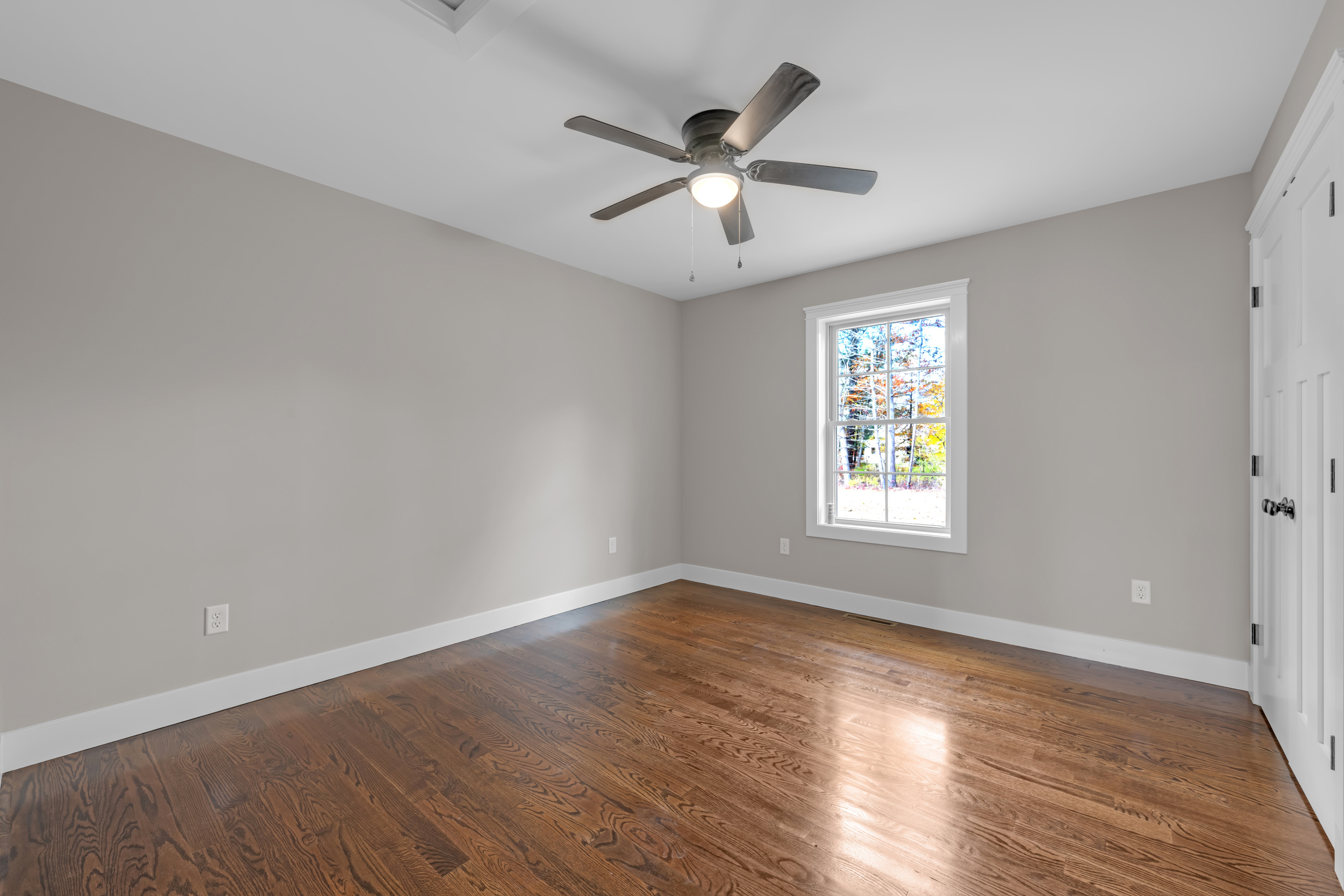 247 Green Hollow Road Killingly, CT 06239 - Photo 23 of 27 an empty room with wooden floor fan and windows