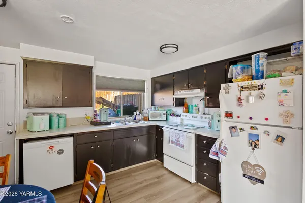 a kitchen with a stove a refrigerator and a refrigerator