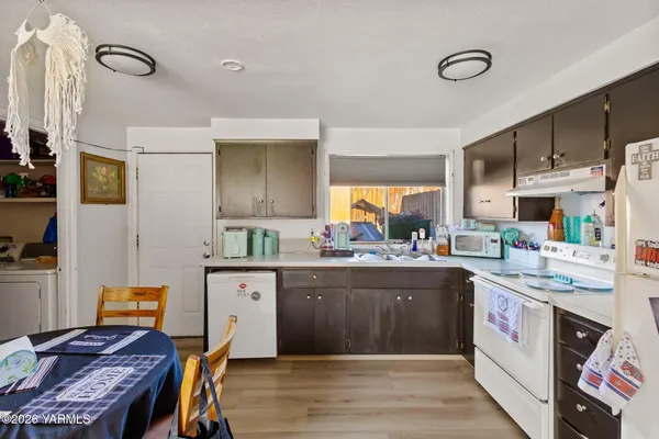 a kitchen with a sink a stove and refrigerator