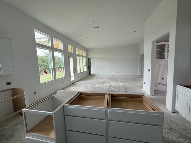 127 Riparian Elm Road Bertram, TX 78605 - Photo 12 of 25 a view of a kitchen that shows a sink and dishwasher with wooden floor