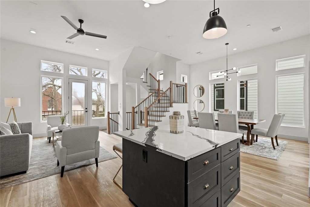 a living room with kitchen island granite countertop furniture and a chandelier