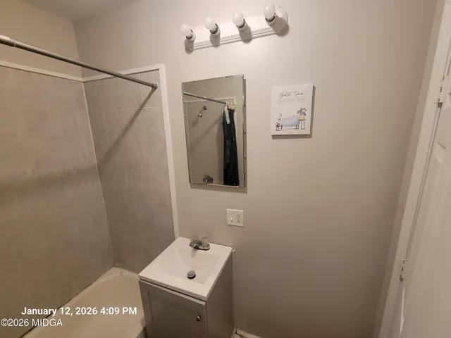 a bathroom with a sink and mirror