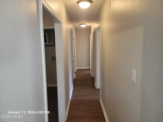 a view of a hallway with a room