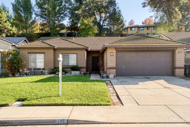 a front view of a house with a yard