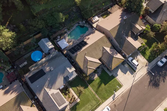 an aerial view of a house with a yard