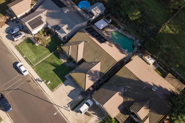 an aerial view of residential houses with outdoor space