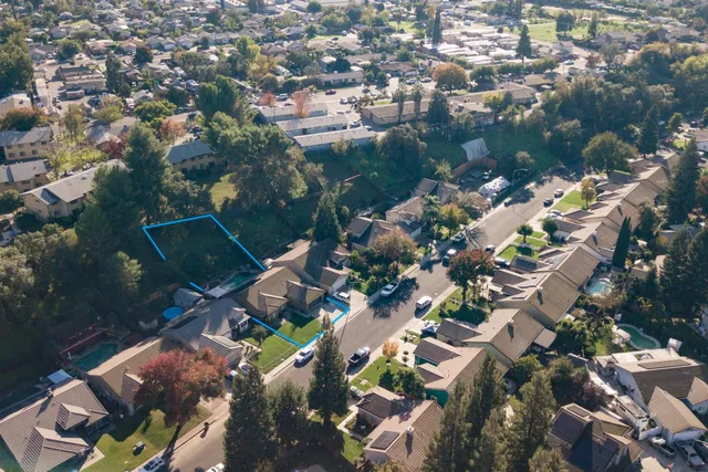 an aerial view of a house with a yard