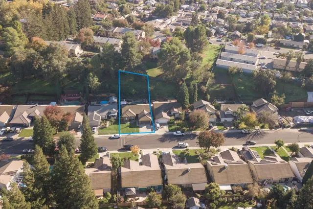 an aerial view of residential houses with city view