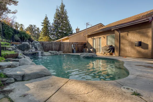 a view of a garden with large trees