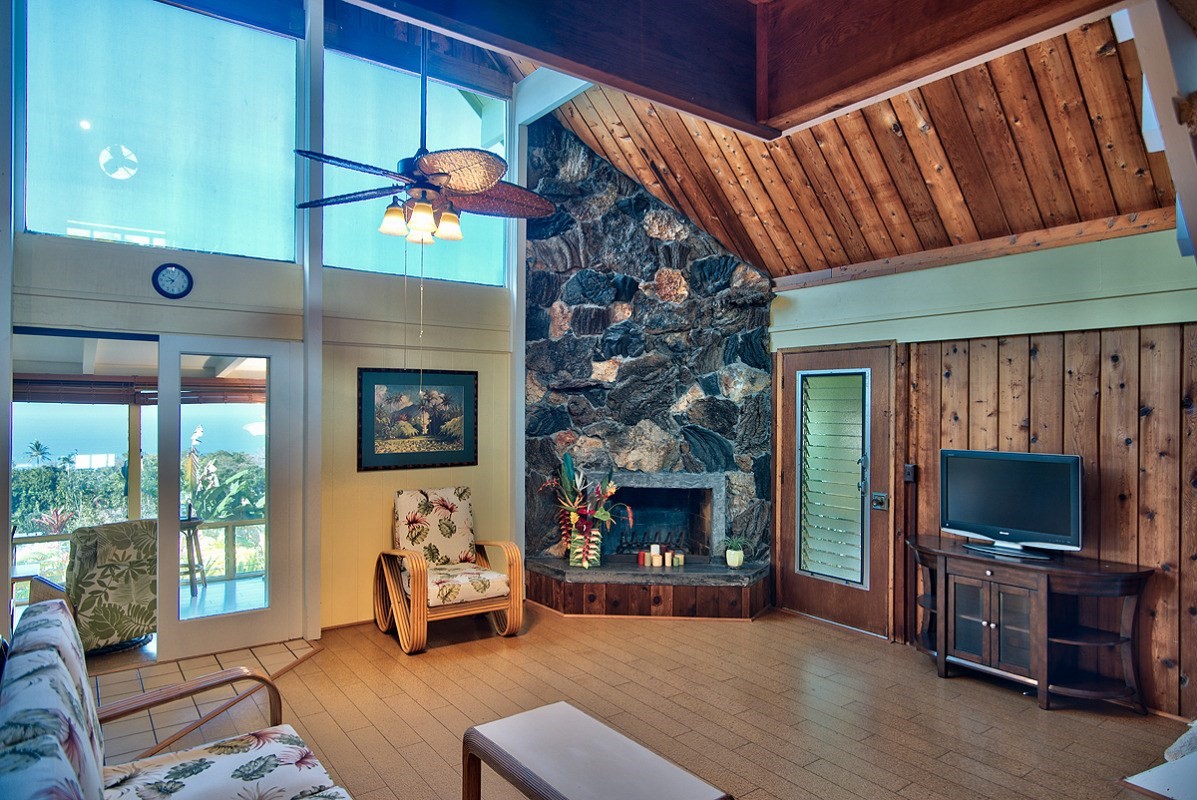81-6263 Piko Road Captain Cook, HI 96704 - Photo 8 of 30 a living room with furniture a flat screen tv and a fireplace