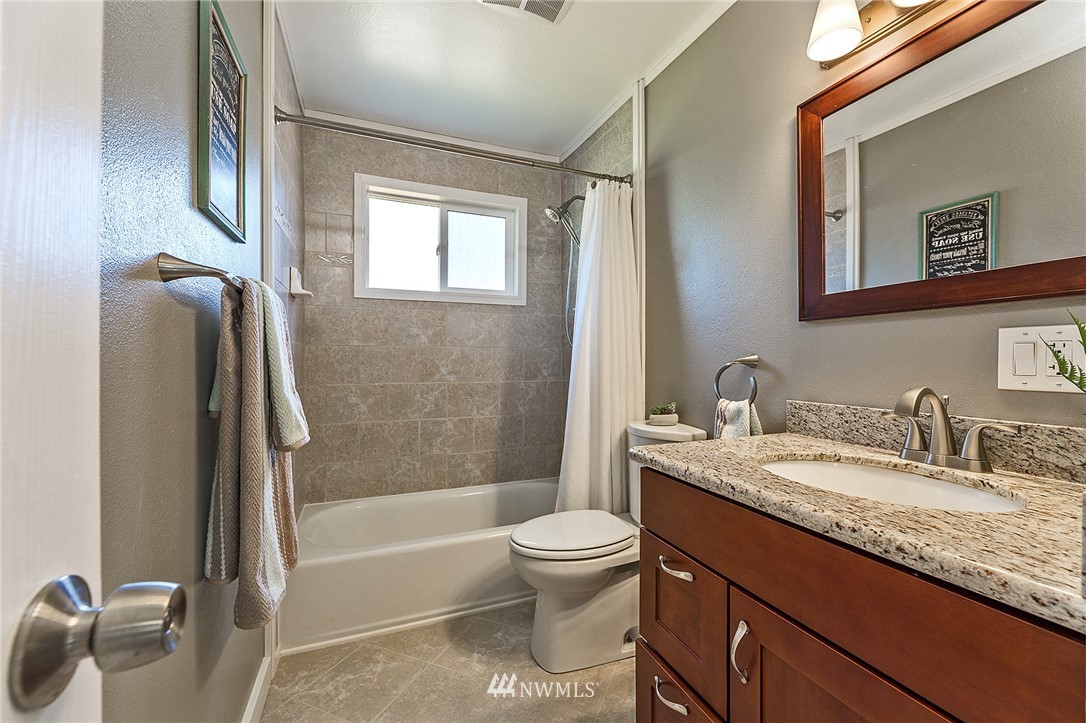 17810 Southeast 121st Place Renton, WA 98059 - Photo 15 of 23 a bathroom with a granite countertop sink toilet and shower