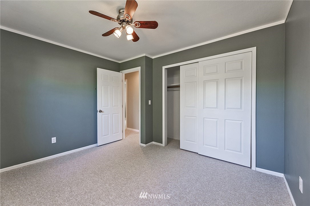 17810 Southeast 121st Place Renton, WA 98059 - Photo 17 of 23 a view of a livingroom with a ceiling fan and carpet