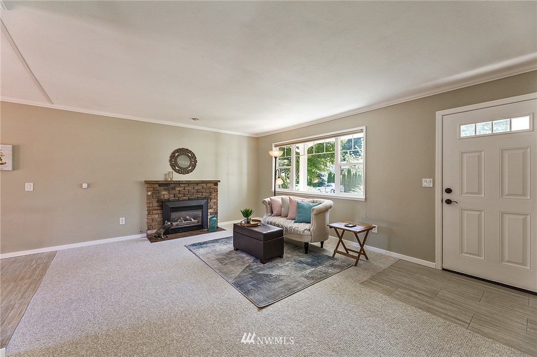 17810 Southeast 121st Place Renton, WA 98059 - Photo 5 of 23 a living room with furniture a fireplace and a window