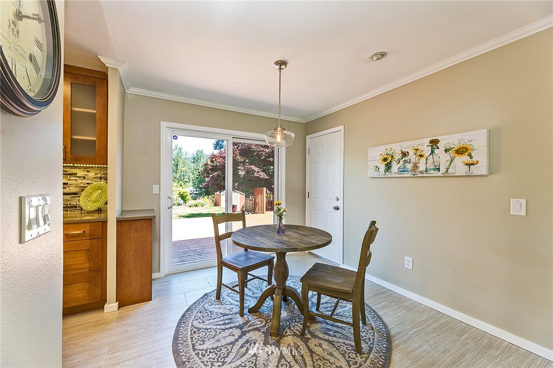 17810 Southeast 121st Place Renton, WA 98059 - Photo 7 of 23 a dining room with furniture a chandelier and wooden floor