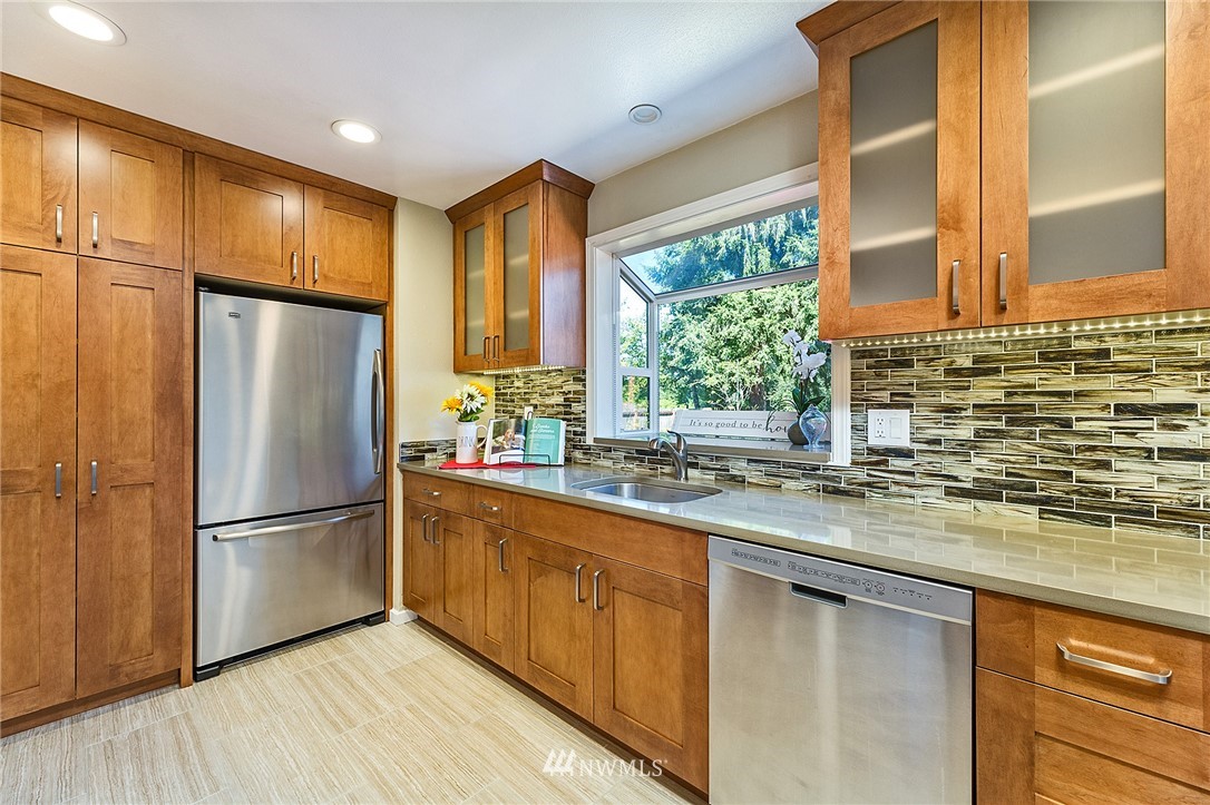 17810 Southeast 121st Place Renton, WA 98059 - Photo 9 of 23 a kitchen with stainless steel appliances granite countertop a refrigerator a sink and a stove
