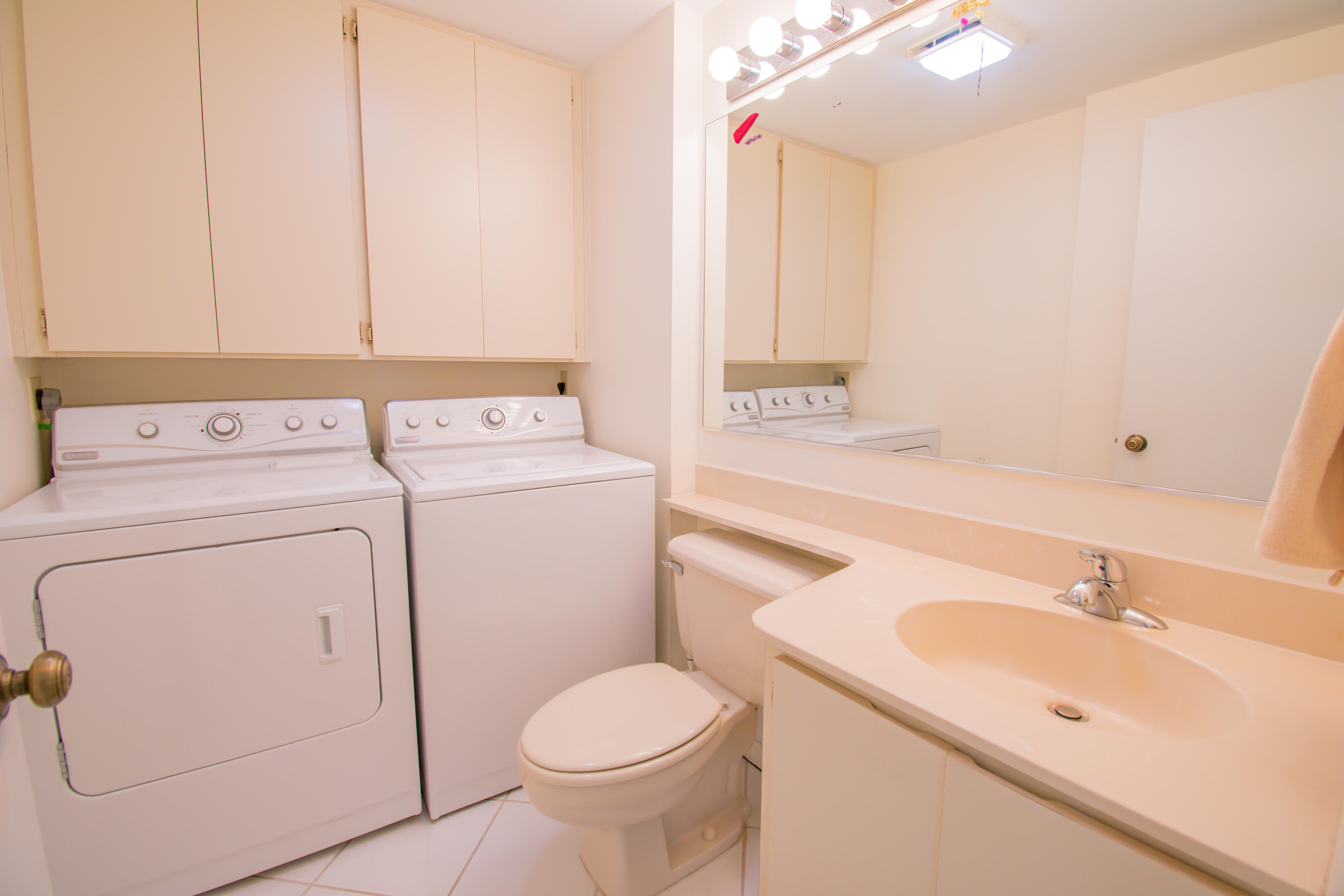 2410 24th Court Jupiter, FL 33477 - Photo 11 of 33 a bathroom with a sink toilet and vanity