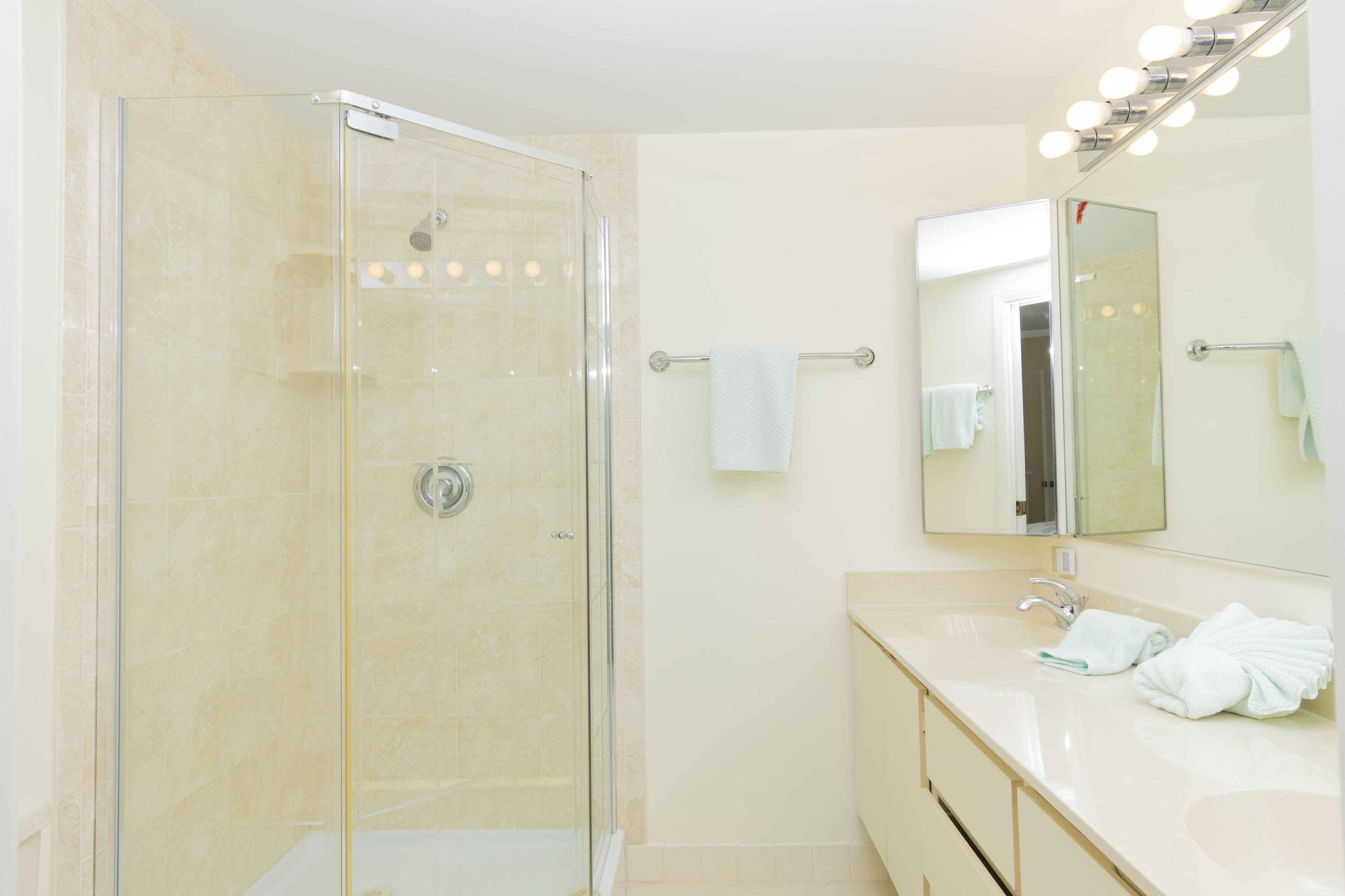 2410 24th Court Jupiter, FL 33477 - Photo 13 of 33 a bathroom with a sink shower and a mirror