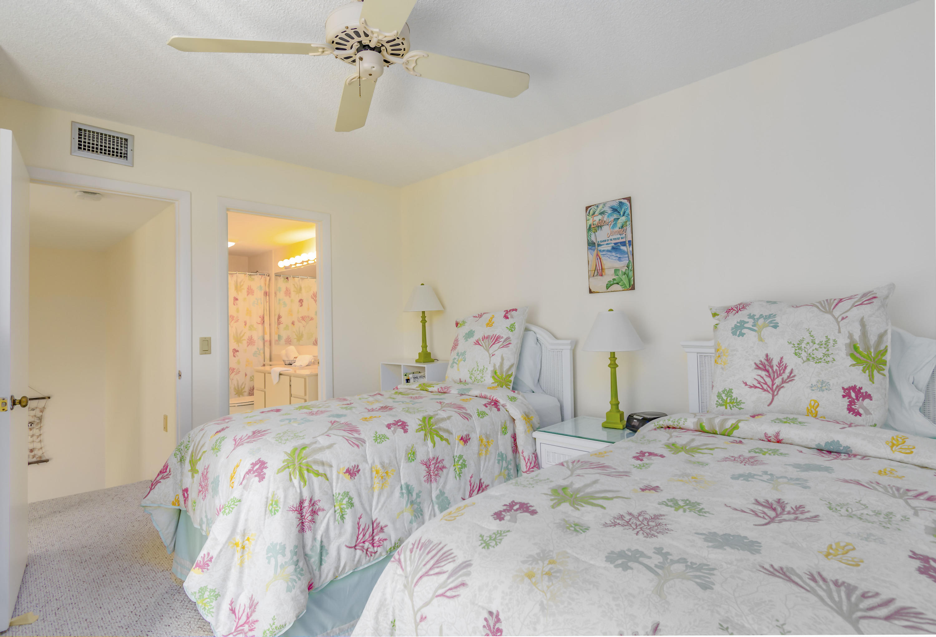2410 24th Court Jupiter, FL 33477 - Photo 16 of 33 a bedroom with two beds and a bed
