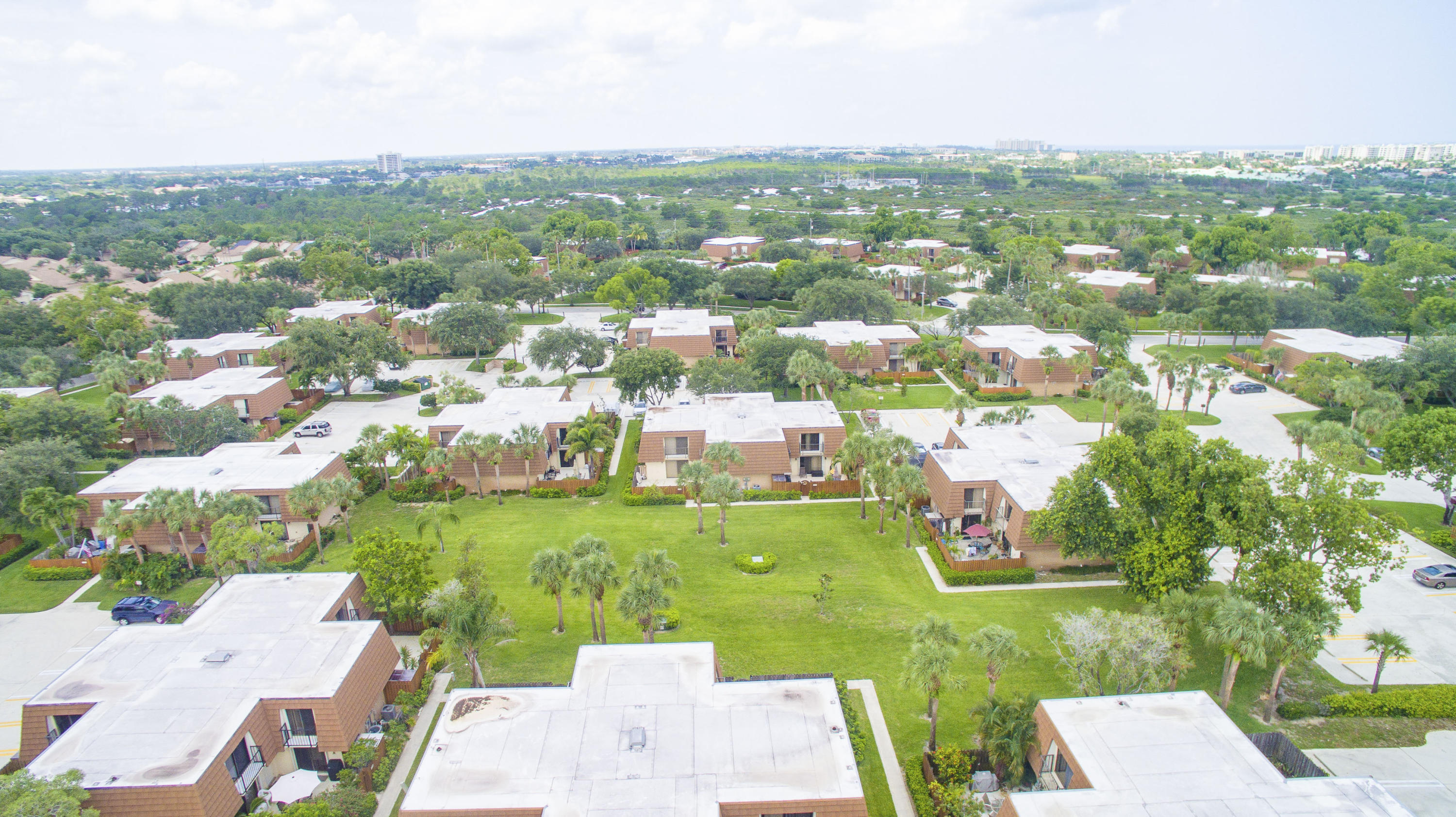 2410 24th Court Jupiter, FL 33477 - Photo 18 of 33 an aerial view of a residential houses with outdoor space and trees all around