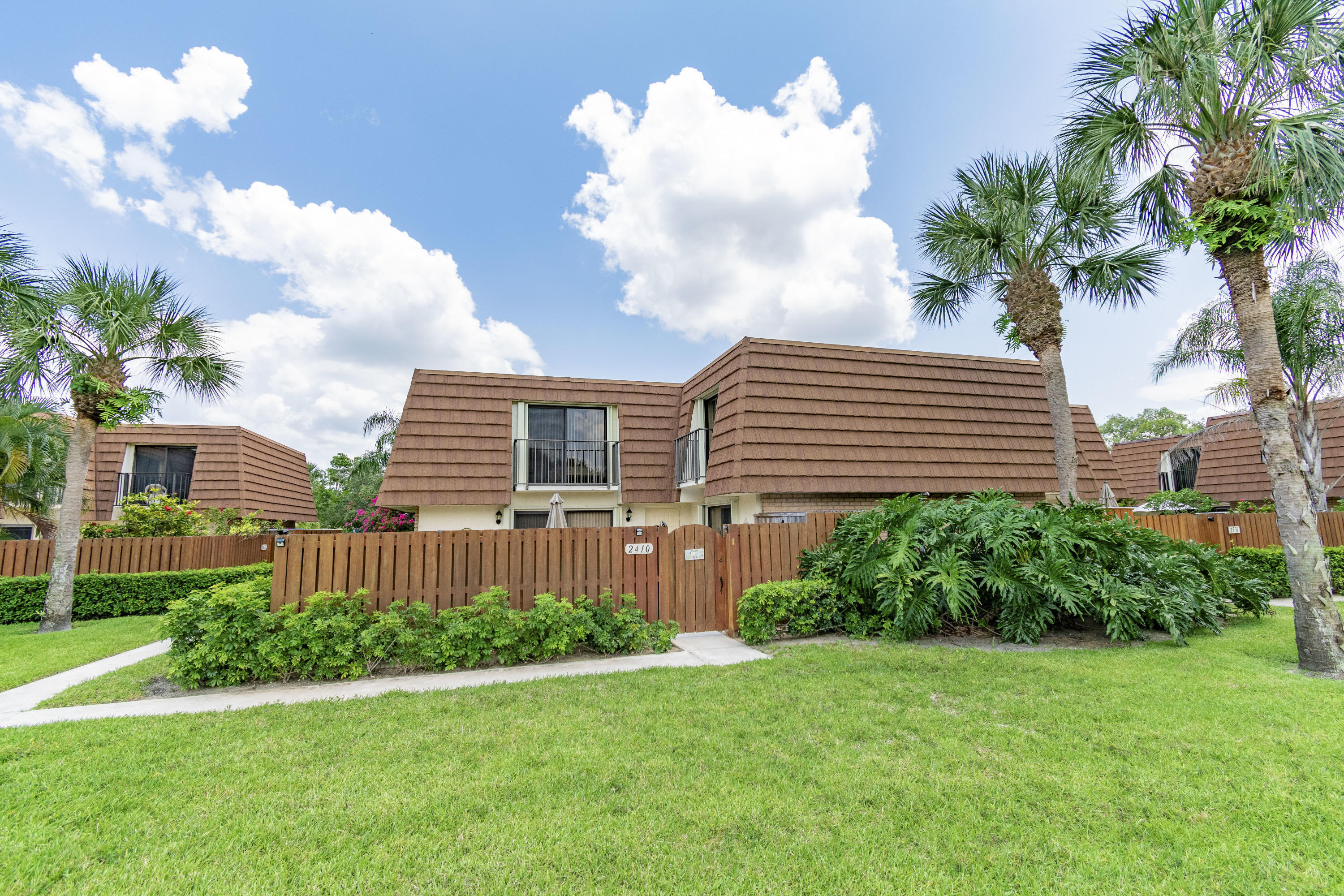 2410 24th Court Jupiter, FL 33477 - Photo 23 of 33 a front view of a house with garden