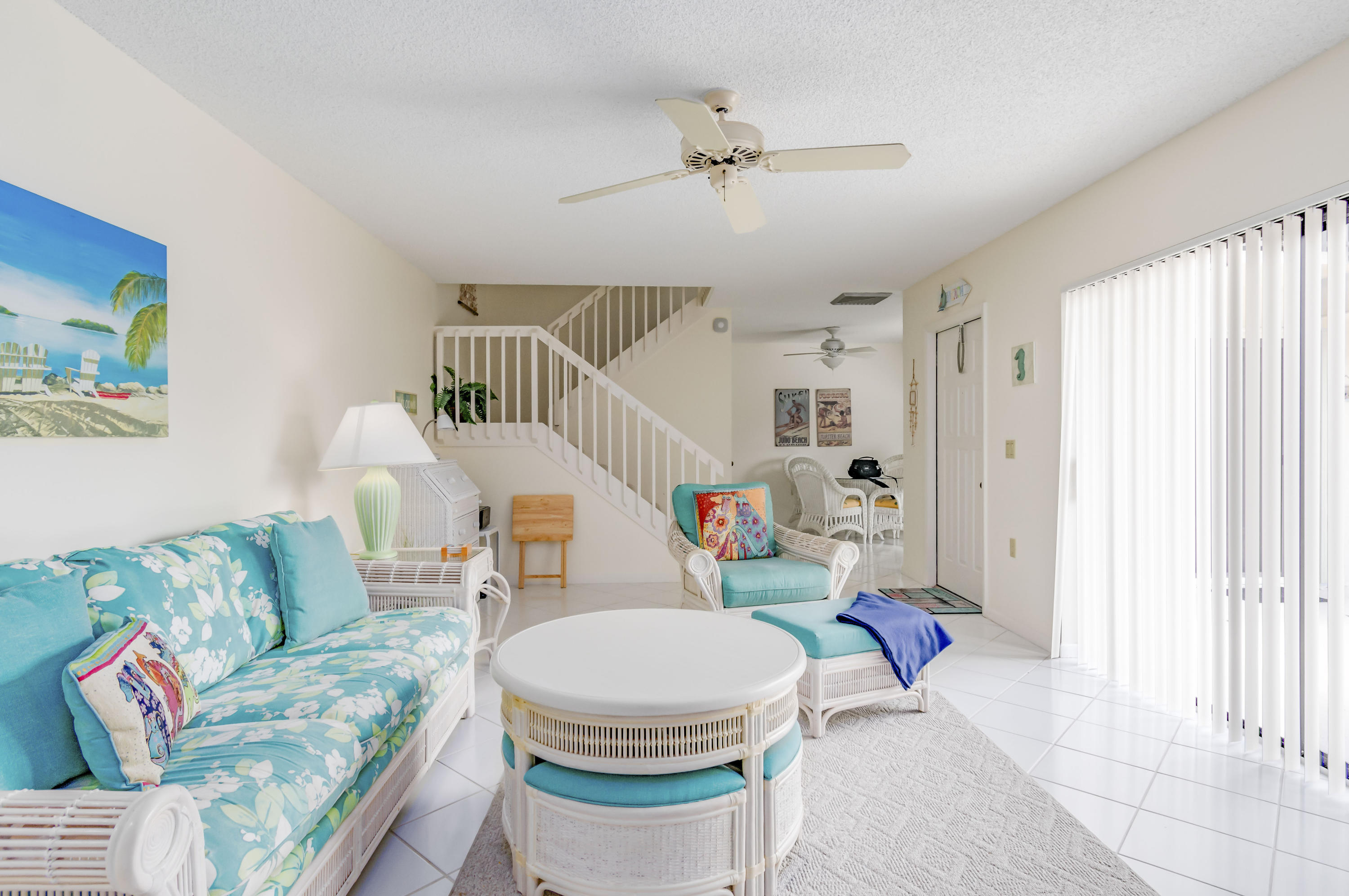 2410 24th Court Jupiter, FL 33477 - Photo 9 of 33 a living room with furniture and a chandelier