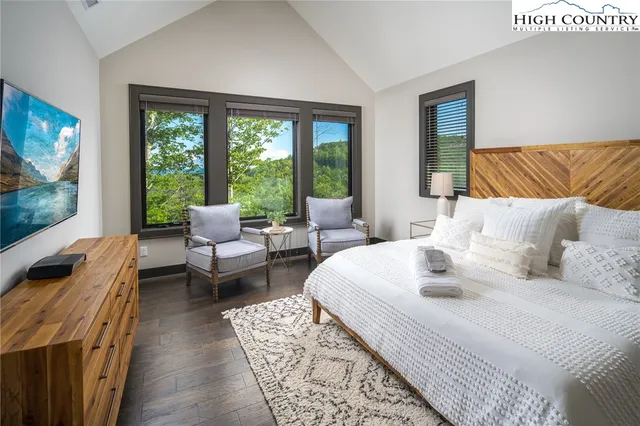 a bedroom with furniture and a flat screen tv