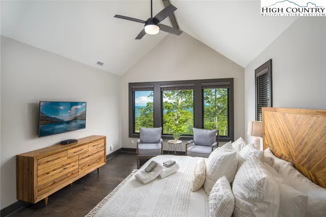a bedroom with a large bed and a chandelier
