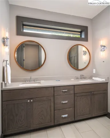 a bathroom with a double vanity sink and a mirror