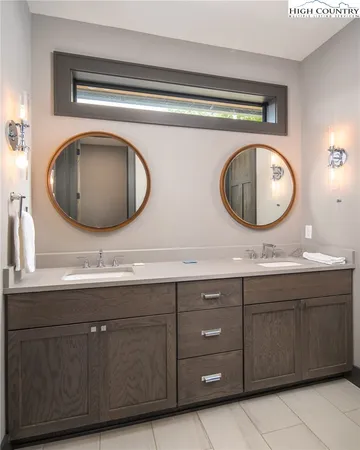 a bathroom with a double vanity sink and a mirror